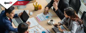 A team of professionals analyzing charts and graphs during a strategy meeting, highlighting Open iT’s software procurement solutions for optimizing license purchases and aligning IT spend with business goals.