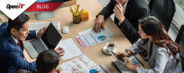 A team of professionals analyzing charts and graphs during a strategy meeting, highlighting Open iT’s software procurement solutions for optimizing license purchases and aligning IT spend with business goals.