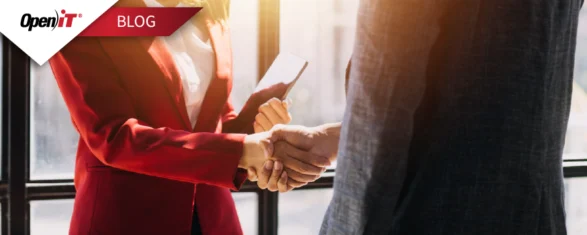business professionals shaking hands in a bright office, representing open it’s software licensing solutions that strengthen partnerships, ensure compliance, and optimize software investments.