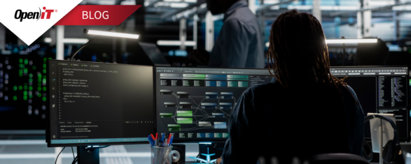 Open iT engineer using StorageAnalyzer to review file systems and storage capacity planning data on multiple monitors, supporting data lifecycle management and enterprise storage management tasks.