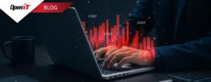 IT professional analyzing declining software cost charts on a laptop, representing hidden costs draining an IT budget