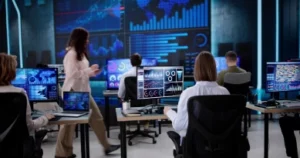 Team monitoring real-time data dashboards on multiple screens in a modern operations center
